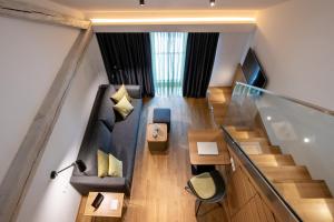 an overhead view of a living room with a staircase at Hotel Thalmair in Munich