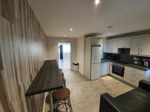 a kitchen with a table and some chairs in it at Large Townhouse in the Heart of Galway No 12 in Galway