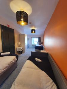 a hotel room with two beds and a wall at Large Townhouse in the Heart of Galway No 12 in Galway