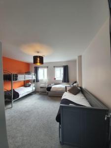 a bedroom with two bunk beds and a living room at Large Townhouse in the Heart of Galway No 12 in Galway