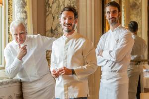 a group of three chefs standing next to each other at Le Meurice – Dorchester Collection in Paris