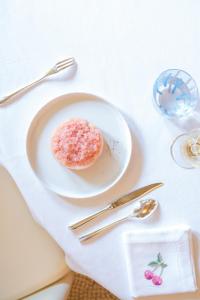a white plate with a pastry on a table at Le Meurice – Dorchester Collection in Paris