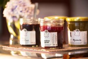 a group of four jars of jam on a shelf at Hôtel Diana Dauphine in Strasbourg