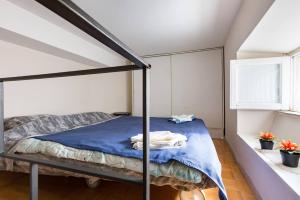 a bedroom with a bunk bed with blue sheets at Parioli Modern Studio in Rome