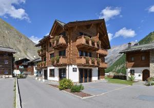 a large brick building with a clock on the side of it at Appartamenti Astra in Livigno