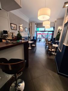 a lobby with chairs and a bar in a restaurant at APART LuX BRISTOL in Bytom