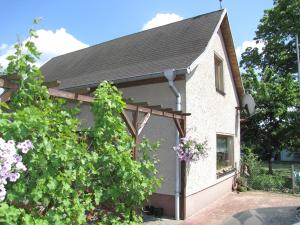 a house with a garage with a tree at 1A Ferienhaus Winter in Dobbertin