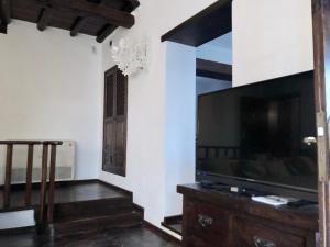 A television and/or entertainment centre at Villa Mare Bella Chao sea view private heated solar pool AC