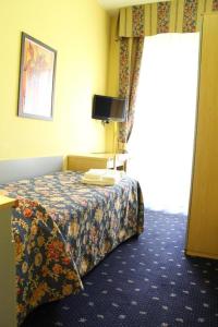 a hotel room with a bed and a window at Hotel Lugano in Milan