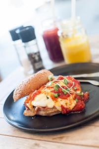 a plate of food with a sandwich on a table at Panoramic Blue B&B in Plettenberg Bay