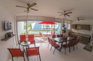 a kitchen and dining room with a table and chairs at Condominio Terrazas del Sol 11 - 202 in Sopetrán