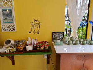 a kitchen with a counter with bowls and dishes on it at Klai Hat Inn in Hua Hin