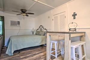 a bedroom with a bed and a table with stools at Pet-Friendly Canyon Lake Studio Fish, Boat, Relax in Canyon Lake