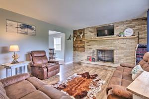 a living room with a couch and a fireplace at Modern Zanesville Escape with Deck and Spacious Yard in Zanesville