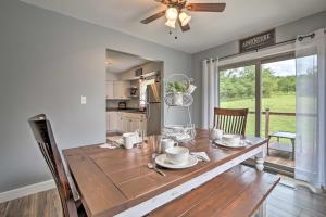 a kitchen and dining room with a wooden table at Modern Zanesville Escape with Deck and Spacious Yard in Zanesville