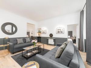 a living room with a couch and a table at LivinParis - Luxury 3 Bedrooms Opera I in Paris