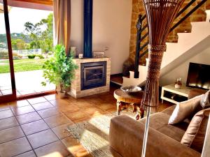 a living room with a couch and a fireplace at Herdade Monte Do Sol in Aljezur