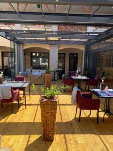 a dining room with tables and chairs and tables and tablesktop at New York Pension in Dunajská Streda