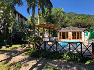 ein Resort mit Pool und Haus in der Unterkunft Pousada Casarão in Boicucanga