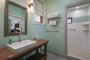 a bathroom with a sink and a shower with a mirror at Moab Springs Ranch in Moab