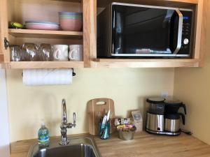 a kitchen counter with a microwave and a cupboard at Moab Springs Ranch in Moab