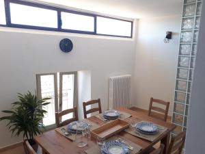 a dining room with a wooden table and chairs at Residenza La Luce di Assisi in Assisi