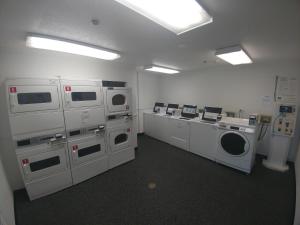 a laundry room with washing machines and a washer and dryer at InTown Suites Extended Stay Chicago IL - Downers Grove in Downers Grove