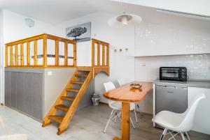 a small kitchen with a table and a loft bed at Apartment Tomas in Split