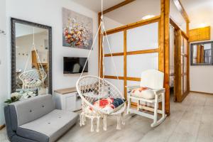 a living room with a swing and chairs at Apartment Tomas in Split