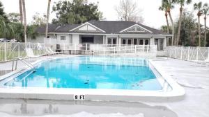 a swimming pool in front of a house at Comfy 1BR Apartment - Ideal for Traveling Nurses & Professionals in Gainesville