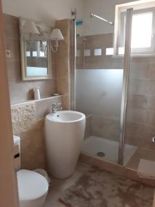 uma casa de banho com uma banheira, um chuveiro e um WC. em Hôtel-Boutique Saint Louis em Lisieux