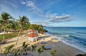 an aerial view of a beach with chairs and a building at Royalton Grenada, An Autograph Collection All-Inclusive Resort in Bamboo