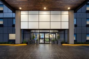 an external view of a building with a large glass door at Holiday Inn Express Puyallup, an IHG Hotel in Puyallup