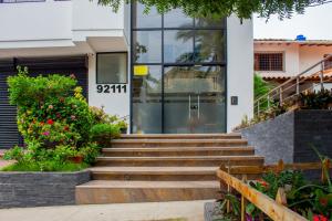 a building with stairs leading up to a glass door at Hotel Boutique M in Barranquilla