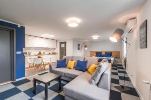 a living room with a couch and a table at Apartamenty Medyka Park in Medyka