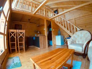 a room with a table and a staircase in a cabin at Lake House Perucac in Rastište