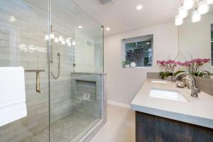 a bathroom with a shower and a sink at The Main Street House - Designer Napa Home in Napa +20 photos