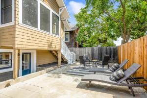 a patio with chairs and a table and a fence at The Main Street House - Designer Napa Home in Napa