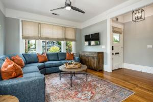 a living room with a blue couch and a table at The Main Street House - Designer Napa Home in Napa