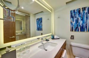 a bathroom with two sinks and a mirror at Royalton Grenada, An Autograph Collection All-Inclusive Resort in Bamboo