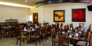 a dining room with wooden tables and chairs at Hotel Soleil Celaya in Celaya