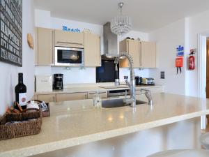 a kitchen with a sink and a counter top at 1 At The Beach in Beesands