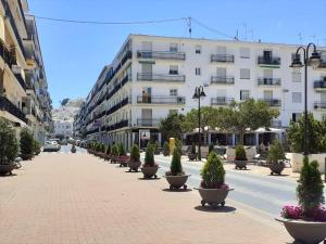 a street with a row of potted plants and a building at FH ALTEA CENTRO PLAYA in Altea