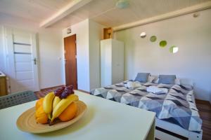 a bowl of fruit on a table in a room at Regem Apartments Płońska in Warsaw