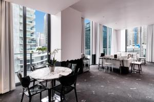 a dining room table with chairs and a large window at SLS Brickell in Miami