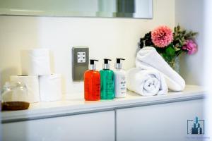 a bathroom shelf with toiletries and towels on it at City View Apartments in Birmingham