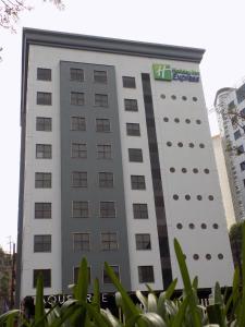a large white building with a green sign on it at Holiday Inn Express Mexico Santa Fe, an IHG Hotel in Mexico City