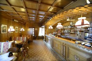 un ristorante con bar, tavoli e sedie di Albergo Valbella a Gallio