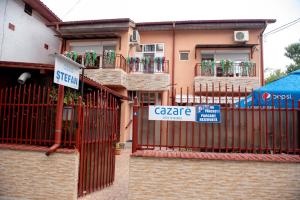 a building with a gate and a sign on it at Casa Ștefan in Eforie Sud