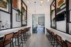 a corridor of a restaurant with chairs and a bar at Holiday Inn Express Monterey - Cannery Row, an IHG Hotel in Monterey